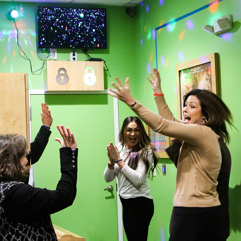 A group celebrating an escape at Breakout Lawrence